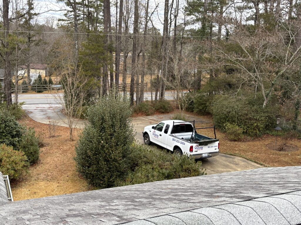Roofer Near Me of NC work truck parked at a residential roofing job in Lillington North Carolina
